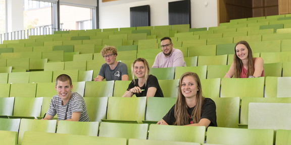 A group of students are sitting in a lecture hall.